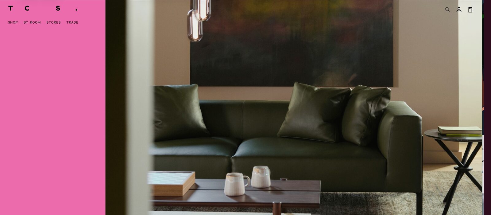 The Conran Shop website, the pink 'TCS' navigation beside a styled interior with a green sofa and artwork