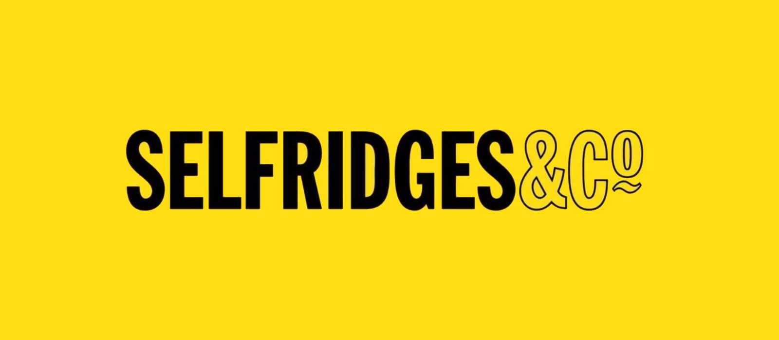 The Selfridges & Co wordmark in black on the brand's signature yellow